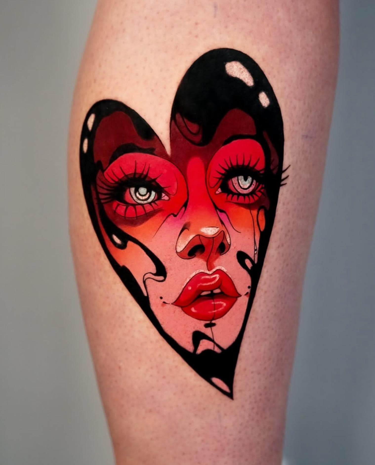 Colorful neo traditional heart-shaped face tattoo on calf