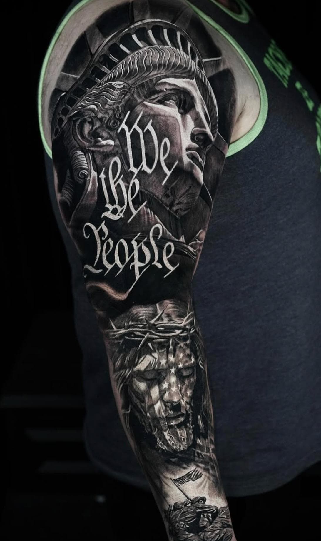 Black and grey realistic Statue of Liberty with script on full sleeve