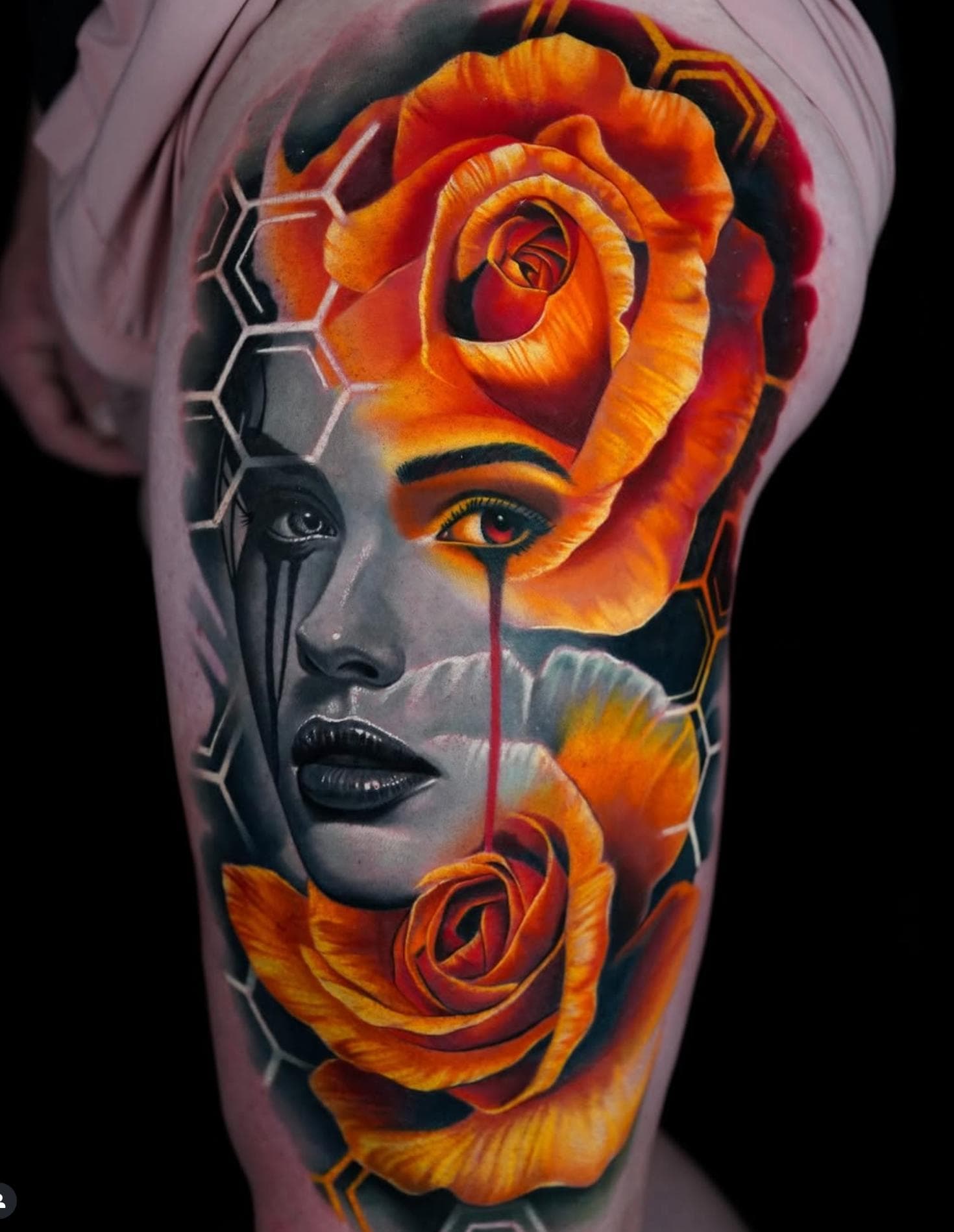 Colorful surrealistic face with roses and geometric patterns on thigh.