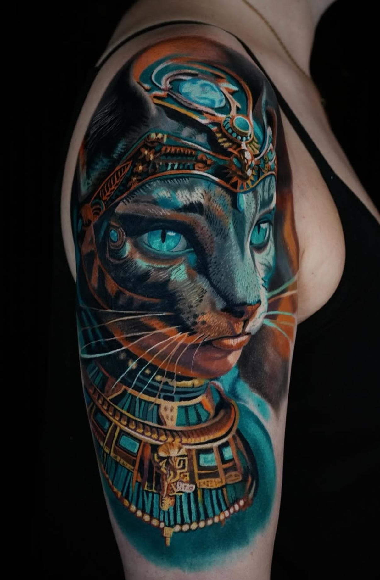 Colorful realistic Egyptian cat tattoo on upper arm