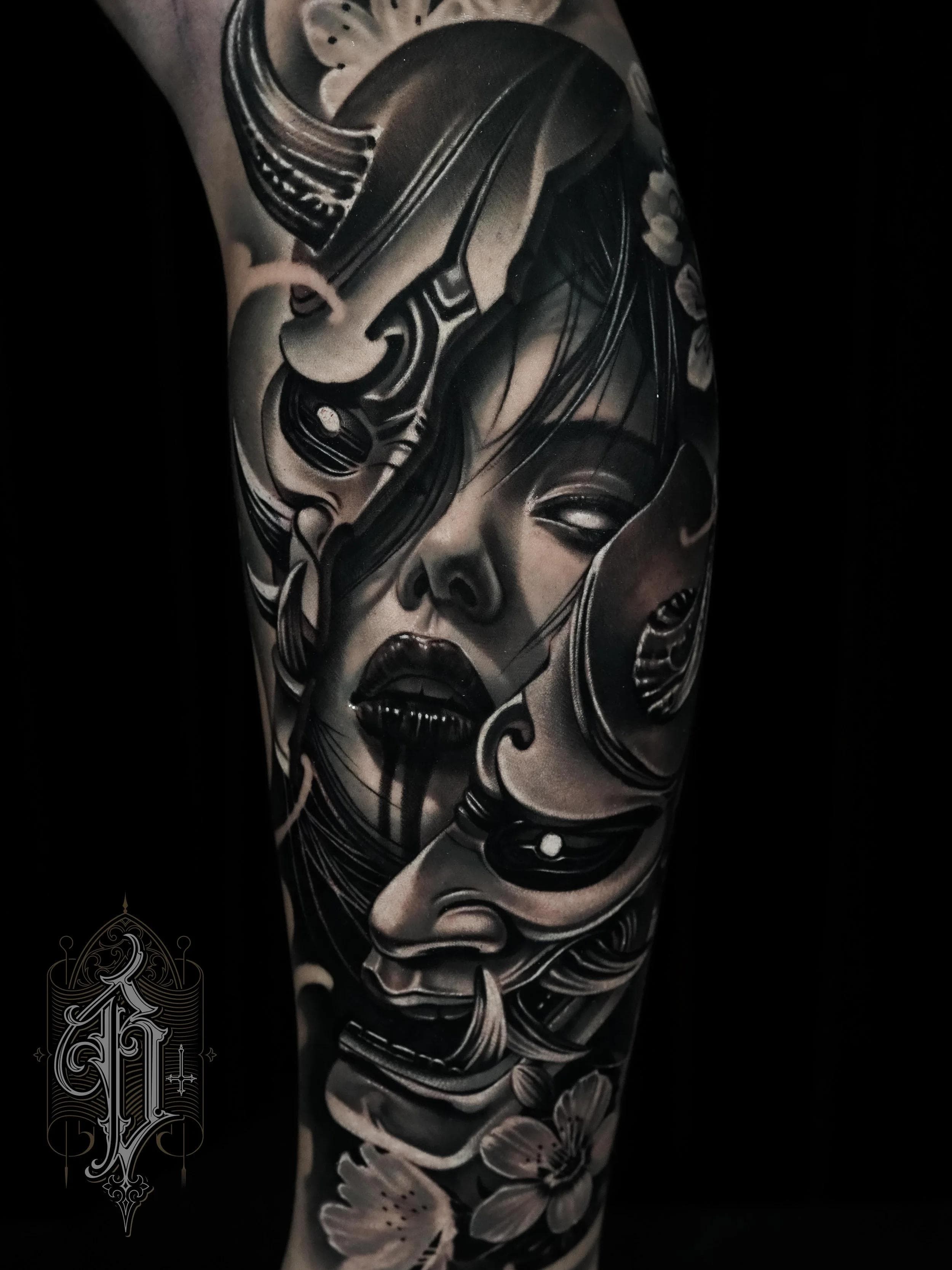 Black and grey realistic Japanese mask and face tattoo on upper arm